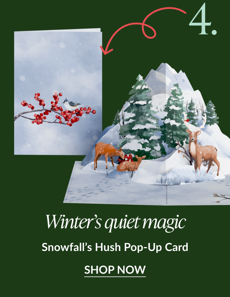 Card with snowy forest and red berries on the cover; inside pop-up shows deer among snow-covered trees; caption “Winter’s quiet magic.”