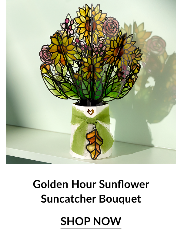 Bright stained-glass-style bouquet of sunflowers and roses tied with a green ribbon and leaf charm; caption “Golden Hour Sunflower Suncatcher Bouquet.”