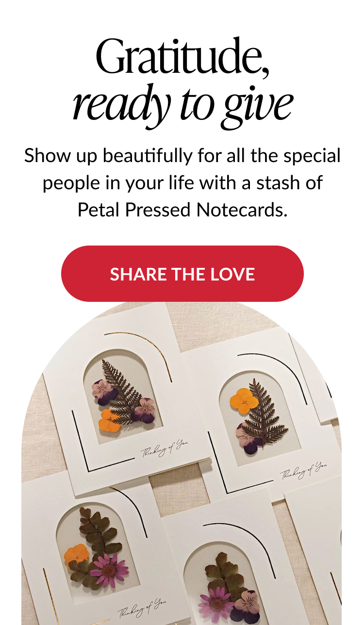 Flat lay of pressed flower notecards with Thinking of You message and Share the Love button