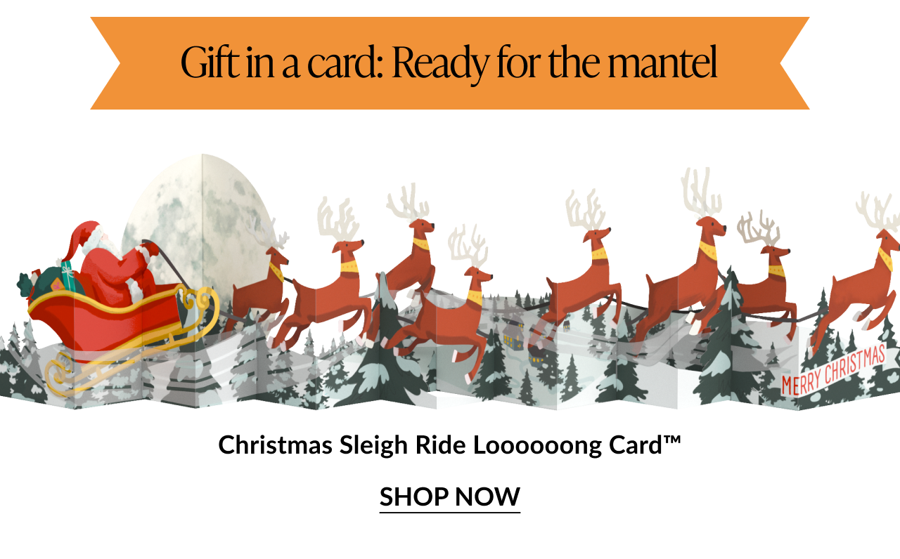 Christmas Sleigh Ride Loooooong Card showing Santa in his sleigh pulled by reindeer across a snowy forest scene with Gift in a card Ready for the mantel banner and Shop Now button