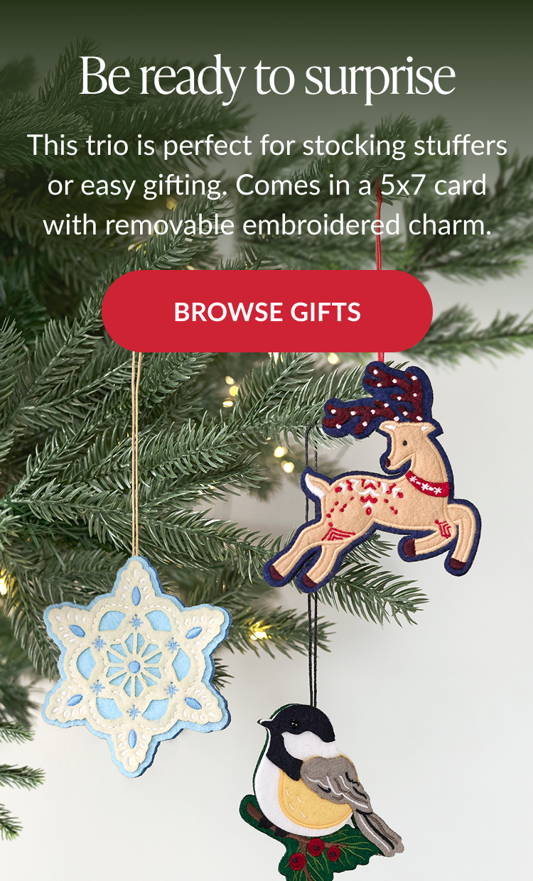 Embroidered reindeer, snowflake, and bird ornaments hanging from a Christmas tree with Browse Gifts button