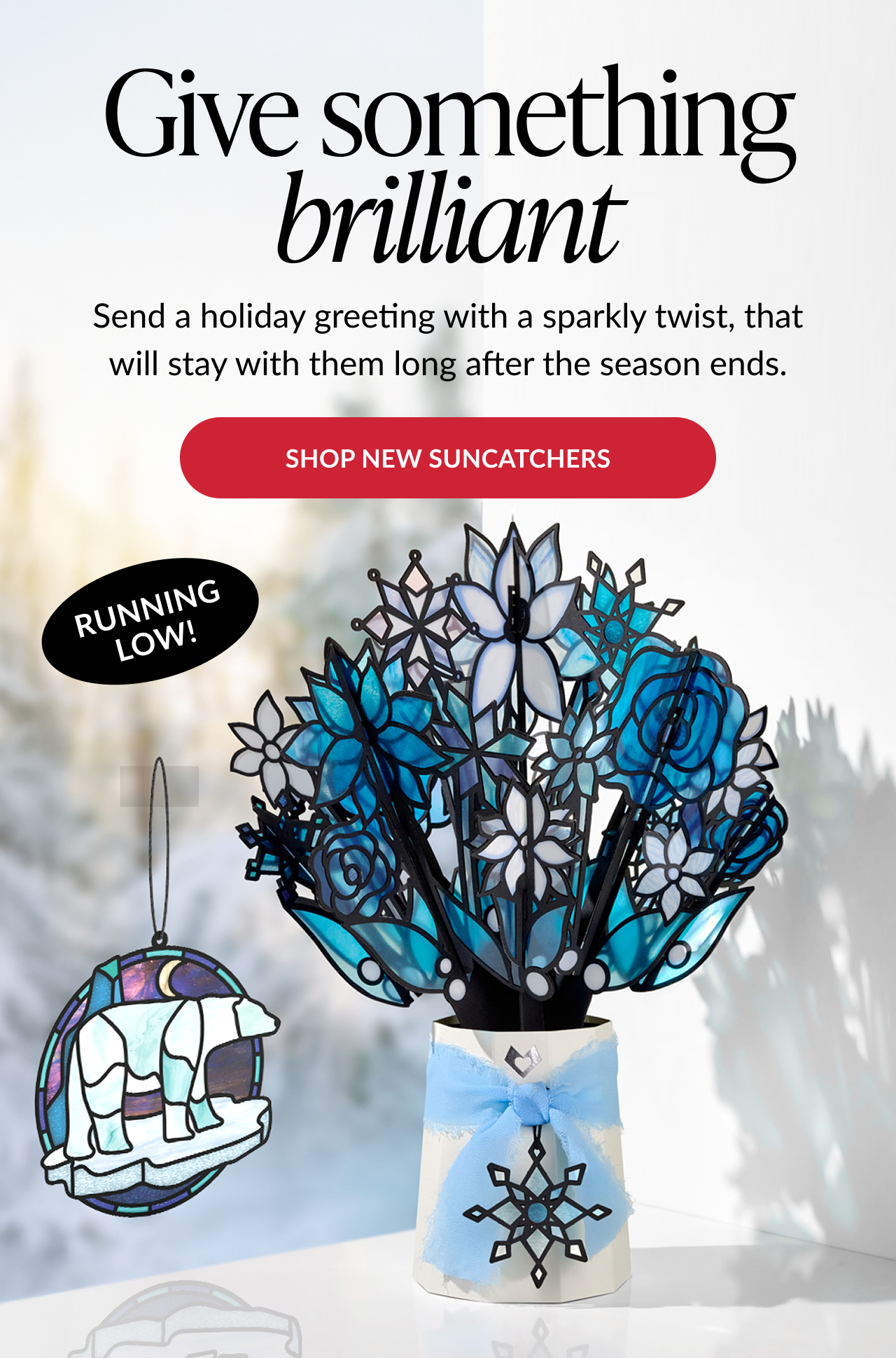 Winter Starlight Suncatcher Bouquet with white and blue stained glass flowers in a vase with a snowflake ribbon