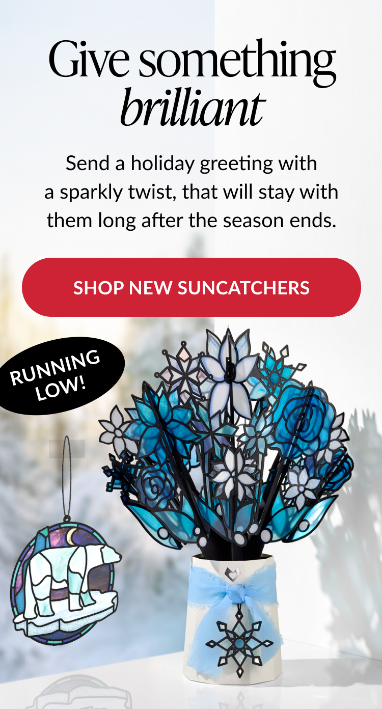 Winter Starlight Suncatcher Bouquet with white and blue stained glass flowers in a vase with a snowflake ribbon
