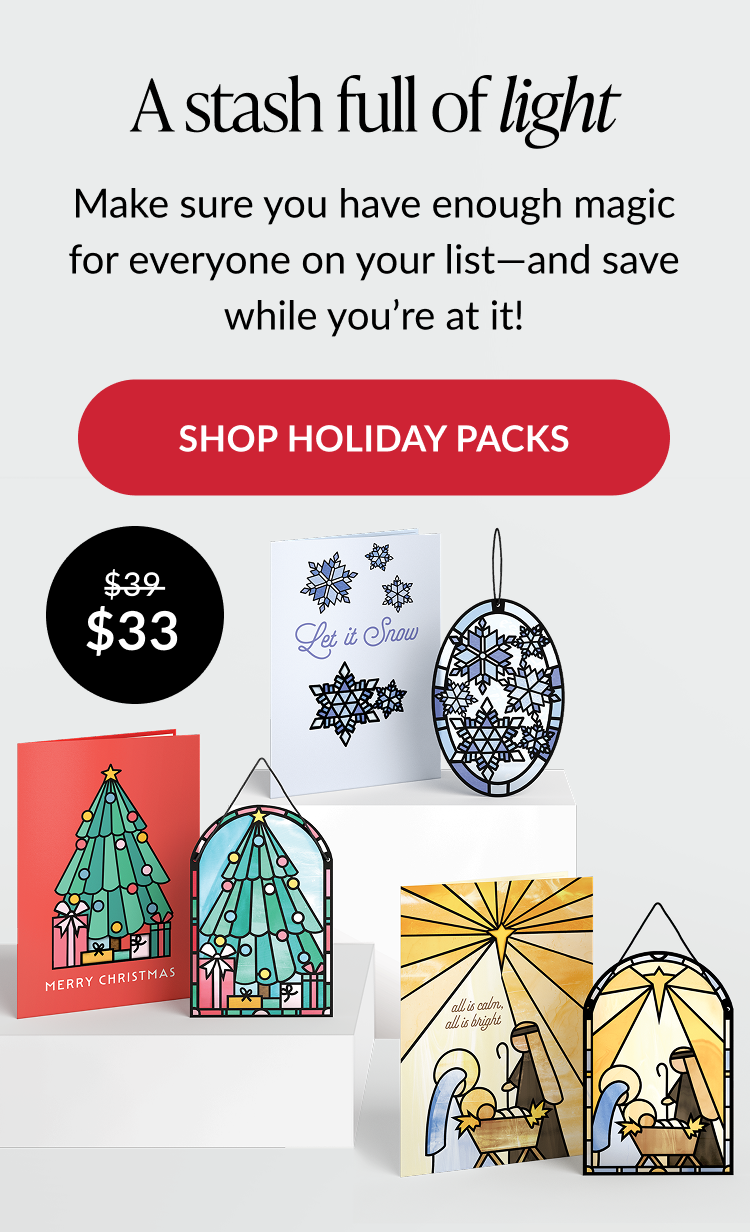 Holiday card set with snowflakes, tree, and nativity suncatcher designs, plus red button reading “Shop holiday packs”