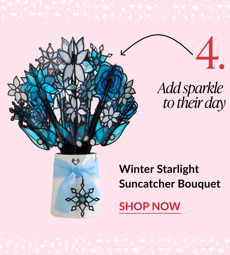 Winter Starlight Suncatcher Bouquet with frosted blue and white flowers in snowflake vase