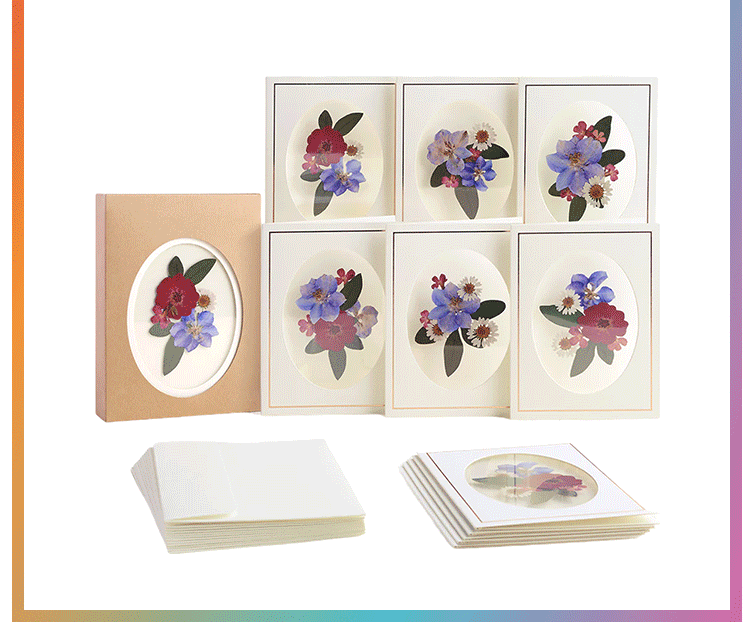 Pressed flower notecard box set with six assorted floral designs and coordinating envelopes displayed with kraft packaging and rainbow border trim
