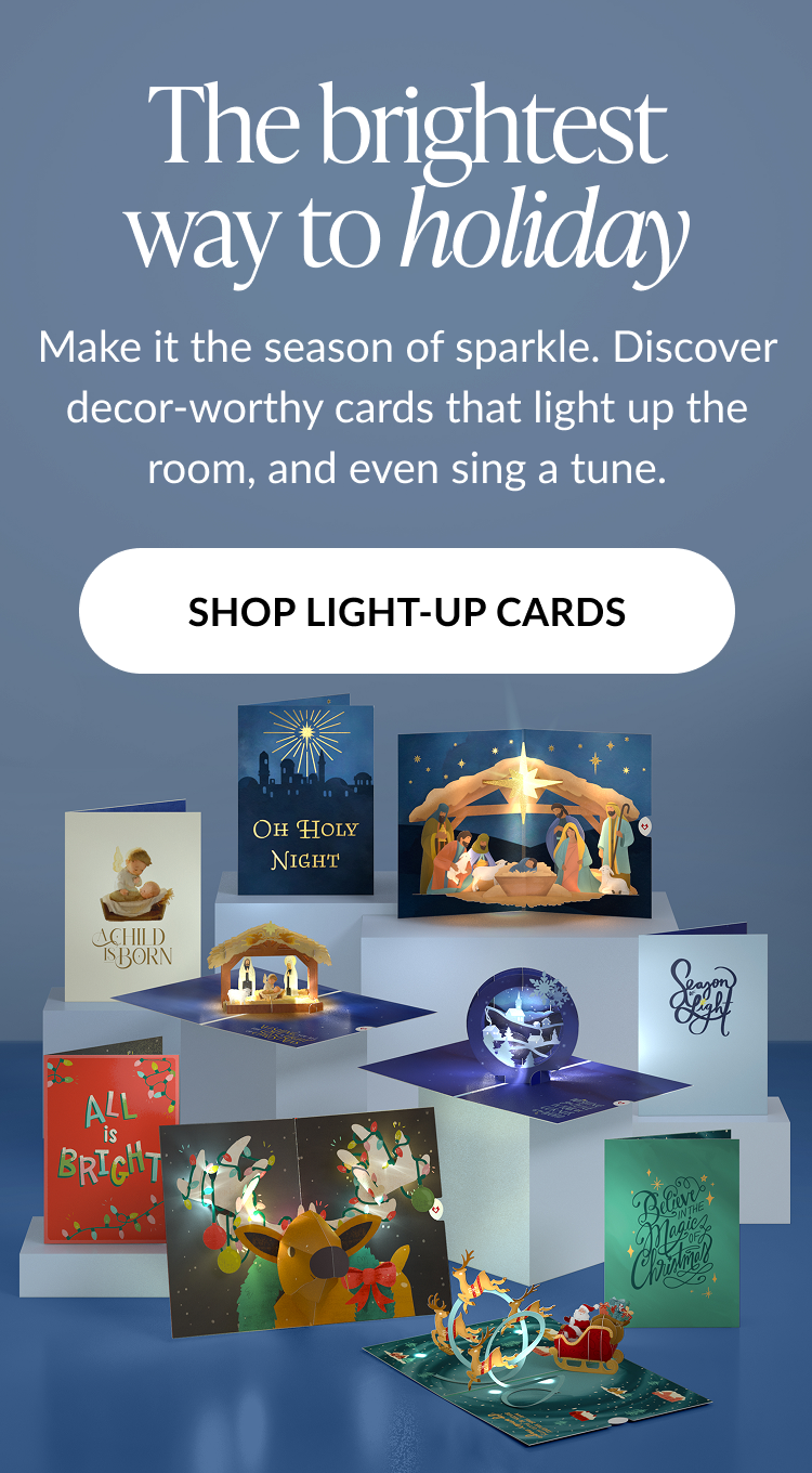 Blue background graphic with headline The brightest way to holiday featuring assortment of light up pop up cards and shop light up cards button