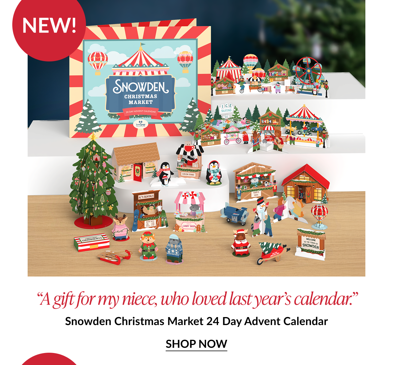 Product photo of Snowden Christmas Market Advent Calendar with miniature Christmas village and penguin figures labeled as new with testimonial quote about a niece loving last year’s calendar