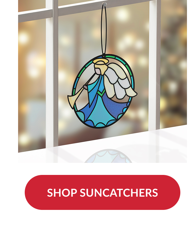 Blue and gold angel suncatcher ornament hanging in a window with blurred holiday lights in background and red button reading shop suncatchers