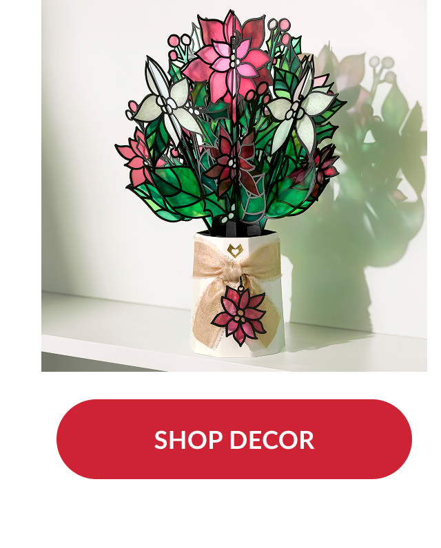 Poinsettia bouquet decor with stained glass look tied with gold ribbon and red button reading shop decor