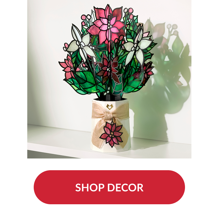 Poinsettia bouquet decor with stained glass look tied with gold ribbon and red button reading shop decor
