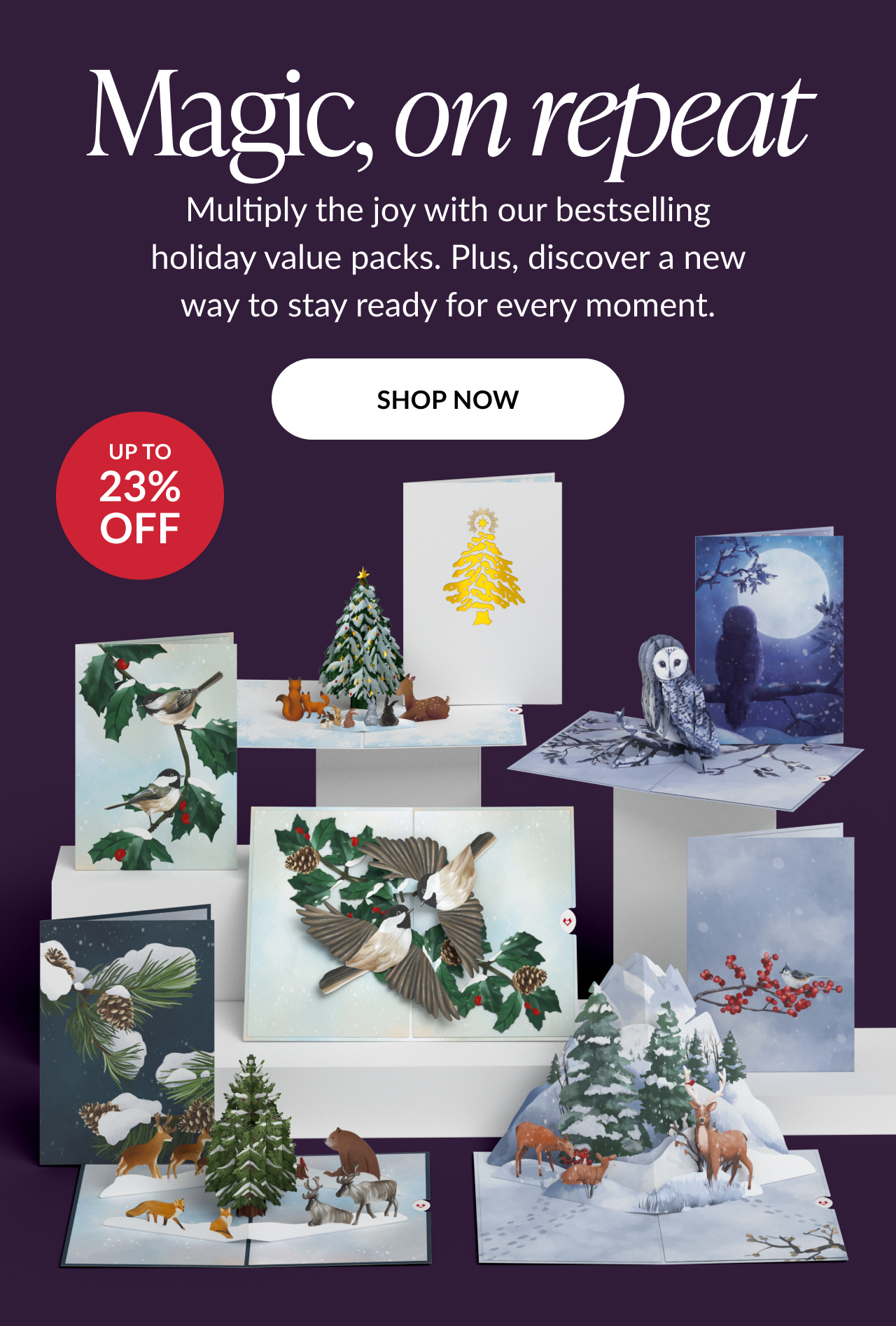 Text on deep purple background reading magic on repeat with description about bestselling holiday value packs and up to 23% off badge above display of pop-up cards featuring winter birds, deer, owls, and Christmas trees with shop now button