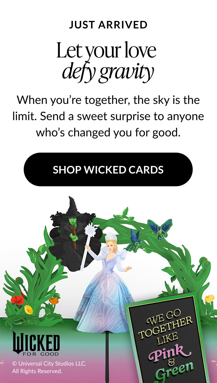 Let your love defy gravity Wicked-themed card with Glinda and Elphaba characters in a green arch design