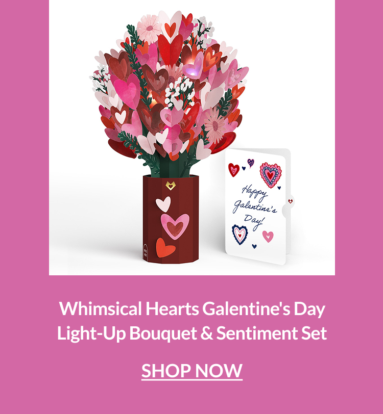 Light-up bouquet of layered pink and red hearts in a vase beside a Galentine’s Day sentiment card.