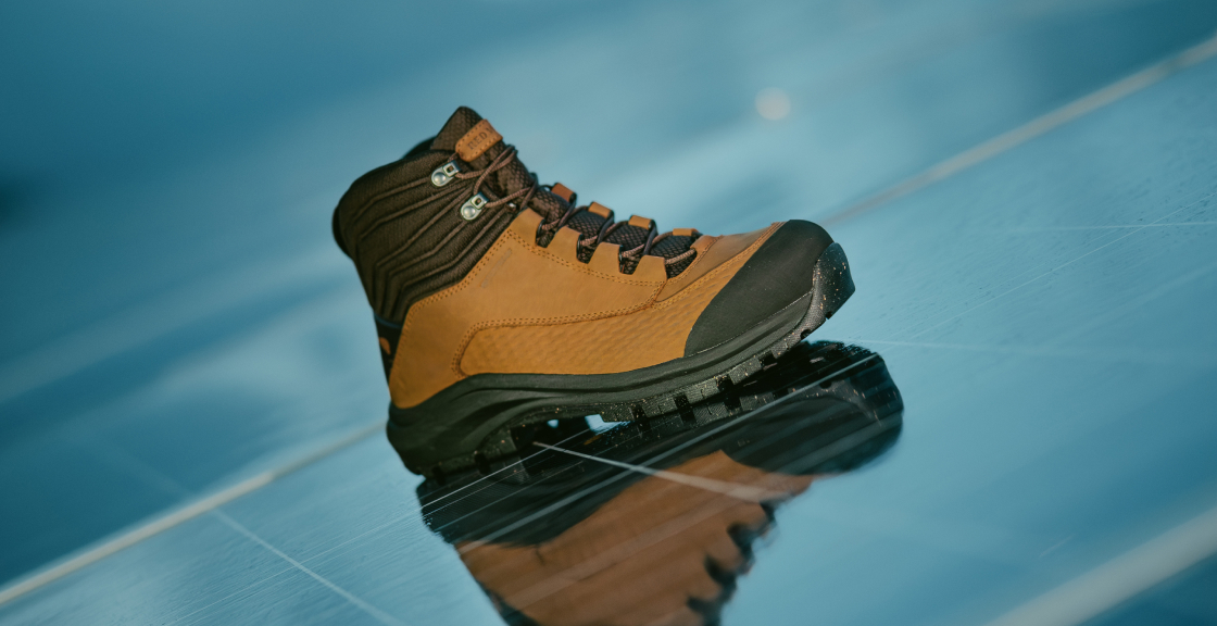 A Red Wing work boot on a reflective solar panel