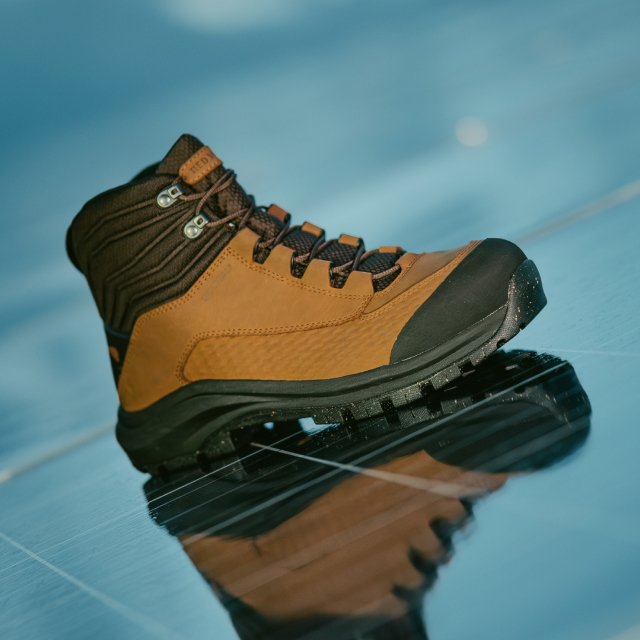 A Red Wing work boot on a reflective solar panel