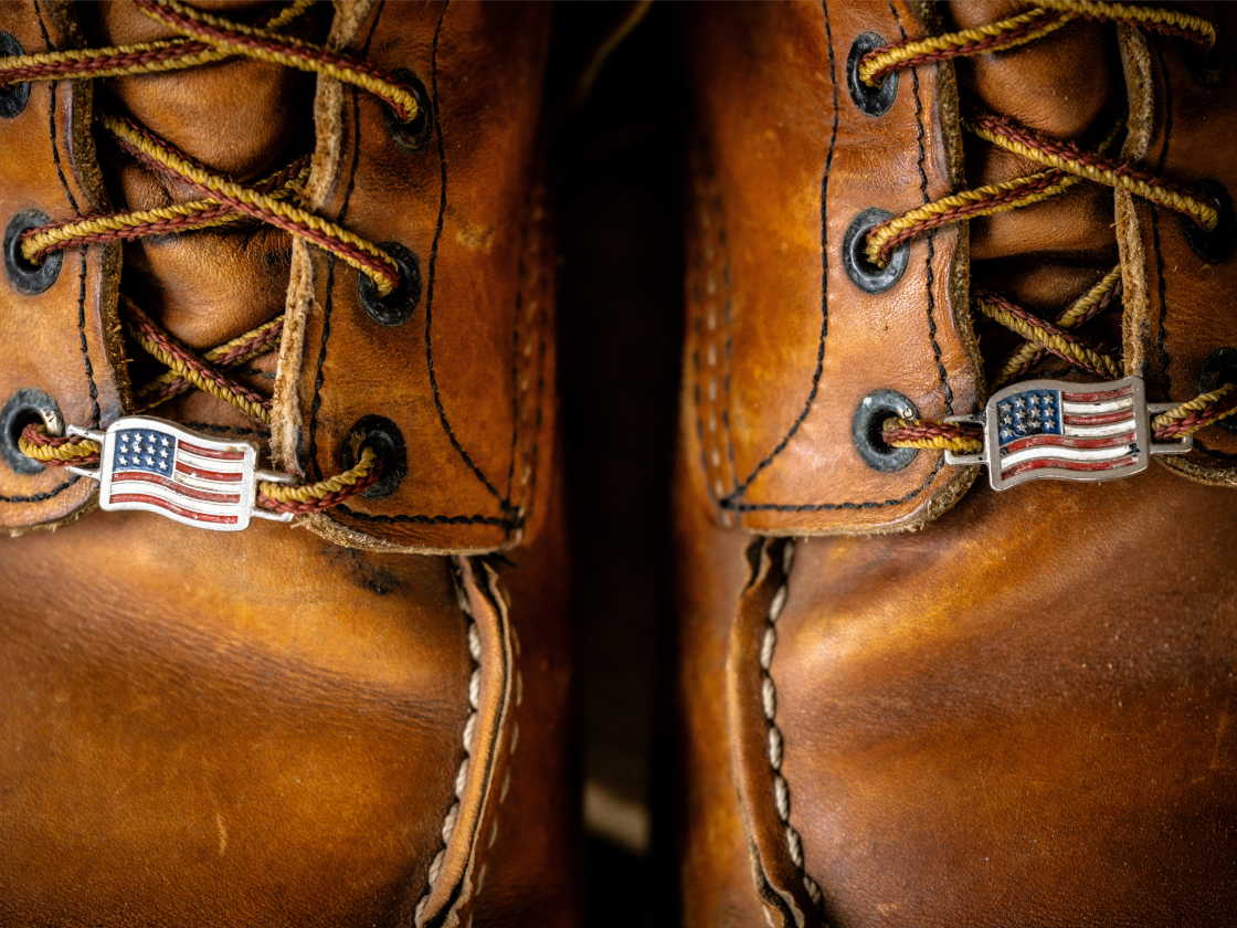 Red Wing boot closeup with an American Flag pin on the laces