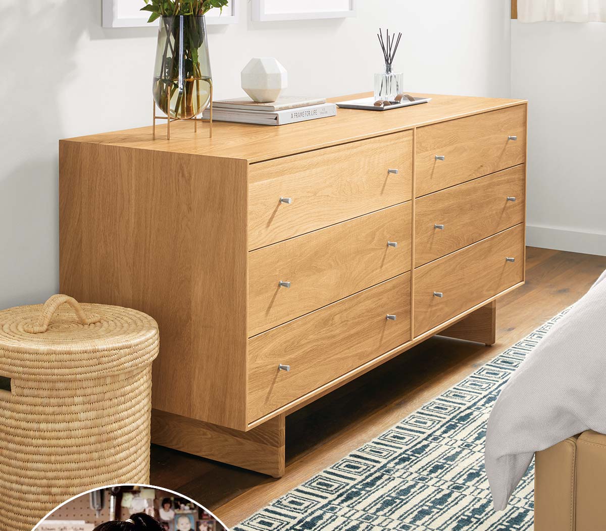 Light wood Hudson dresser beside woven basket, rug underfoot, and framed art above.