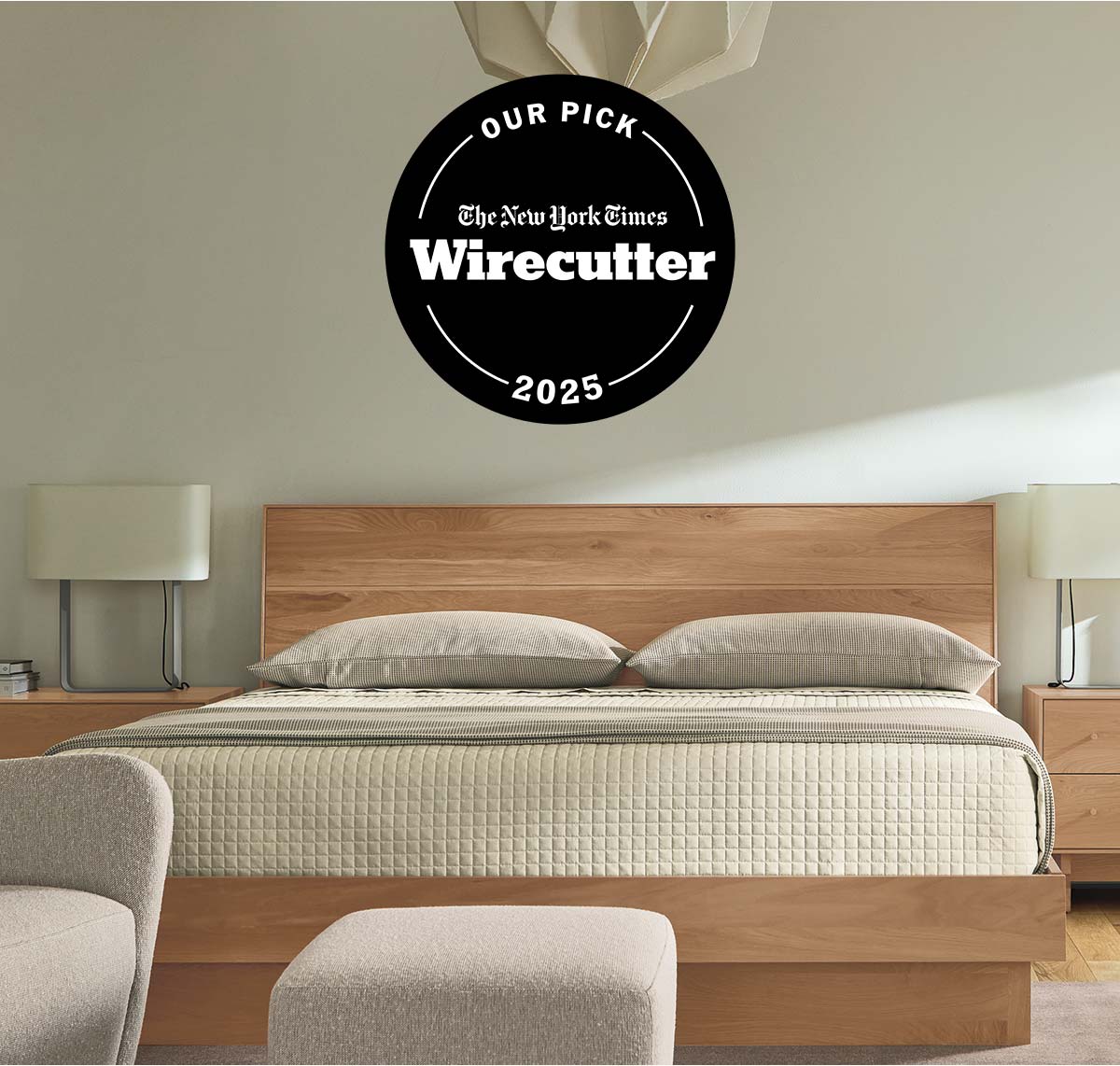 Hudson bed with NYT Wirecutter 2025 badge above headboard, shown with beige bedding and matching nightstands.