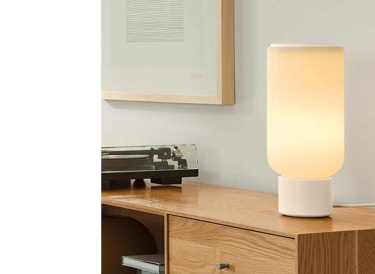 Arpeggio table lamp on oak console with turntable, book storage and framed abstract art.