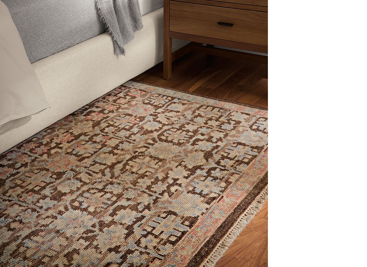 Close-up of vintage-style Rosalie rug with a warm palette of terracotta, brown, and blue.