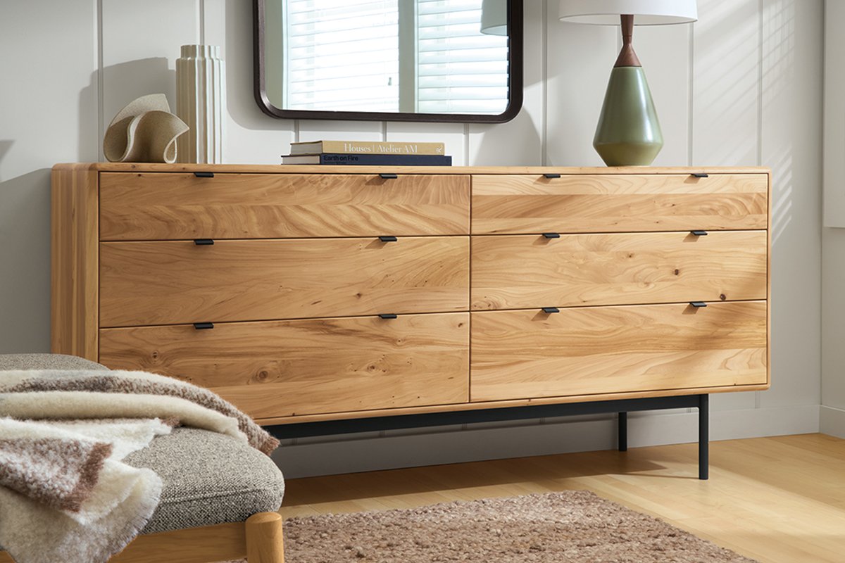 Hensley dresser in reclaimed elm, showing natural knots and grain, styled with a mirror, table lamp, and decor.