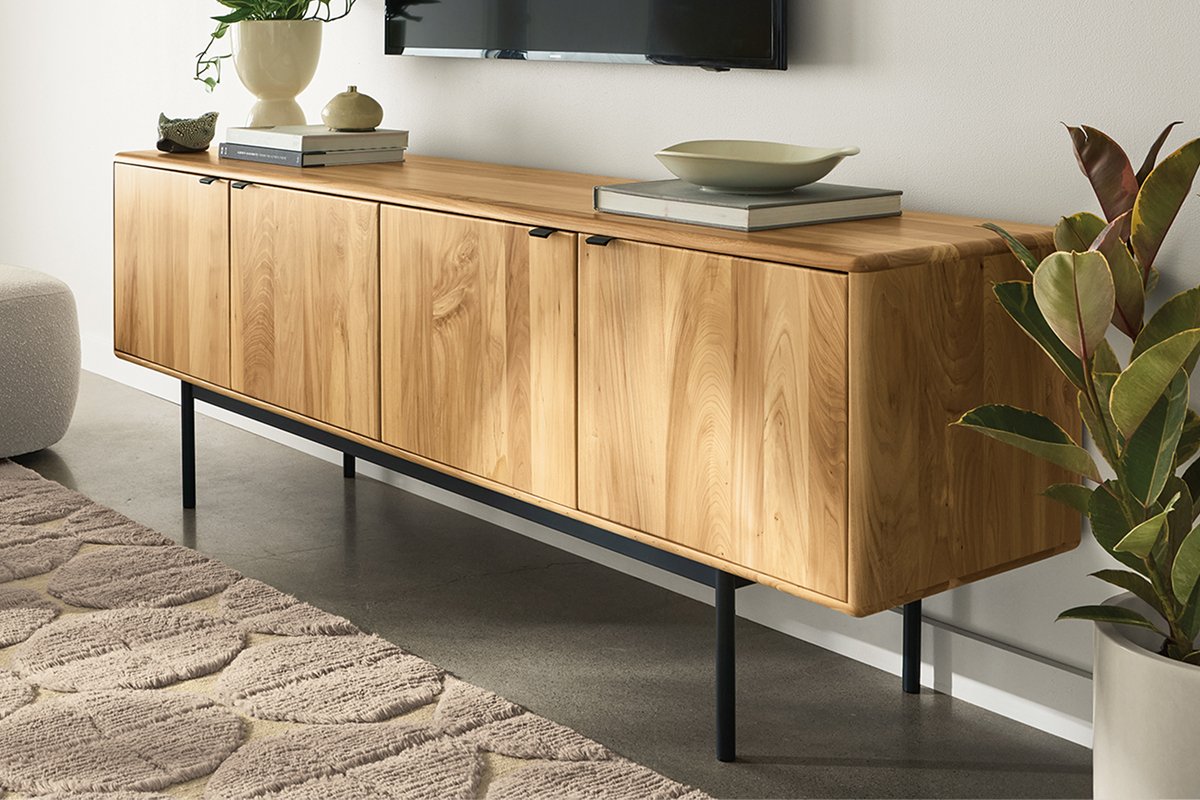 Hensley media cabinet in reclaimed elm with plants and decor beneath a wall-mounted TV.