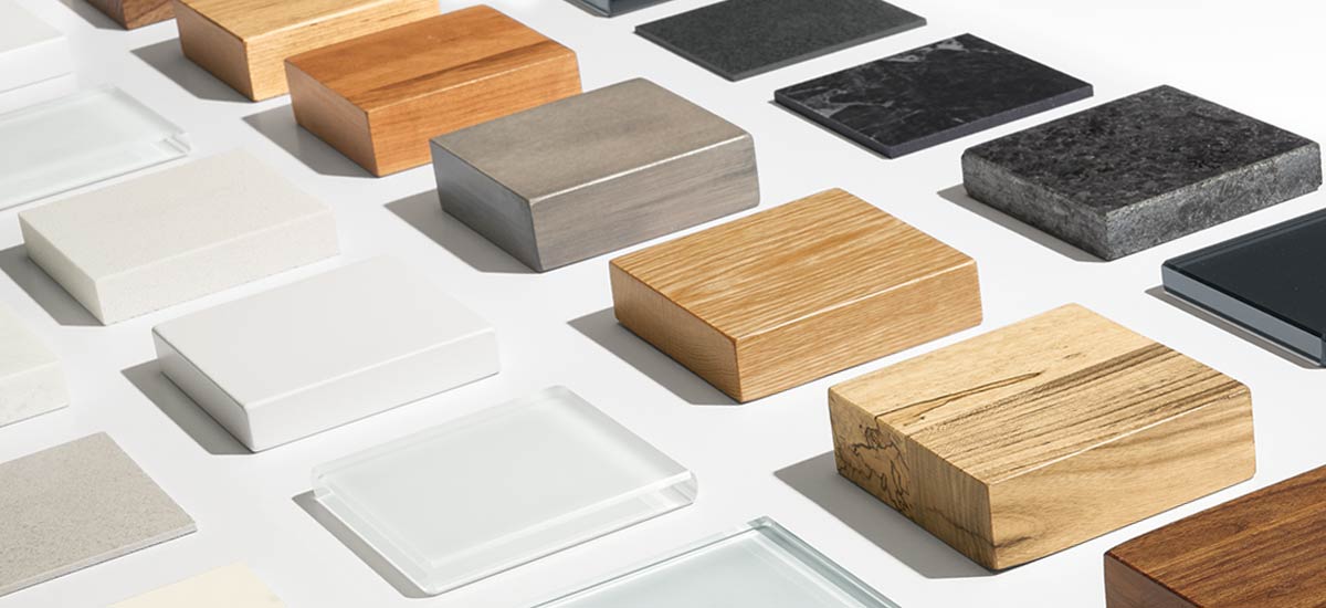 Glass, stone and wood top material samples lined up in rows.
