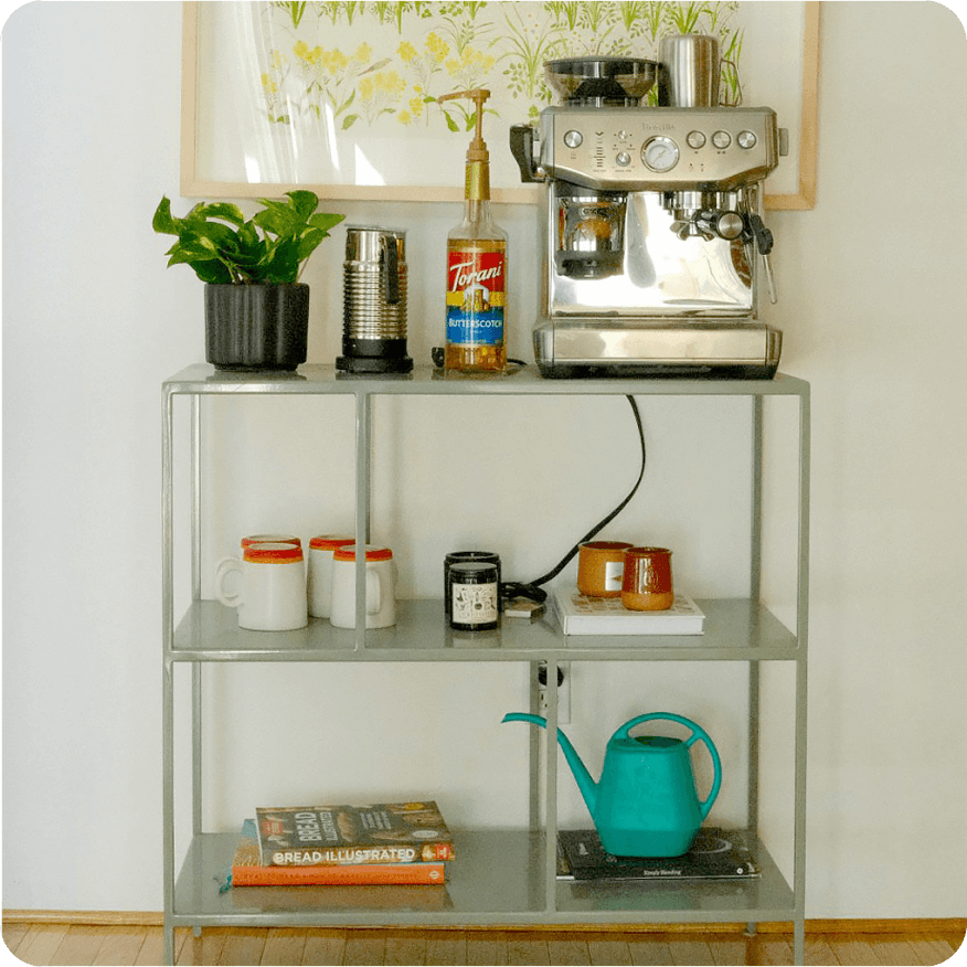 Grey Foshay bookcase used as a coffee station with espresso machine, mugs and supplies.