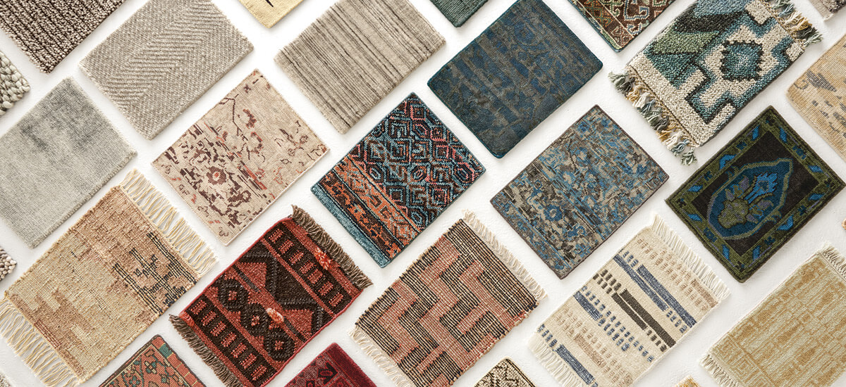 Diagonal layout of assorted rug swatches in various patterns and colors, including reds, blues, neutrals, and geometrics.