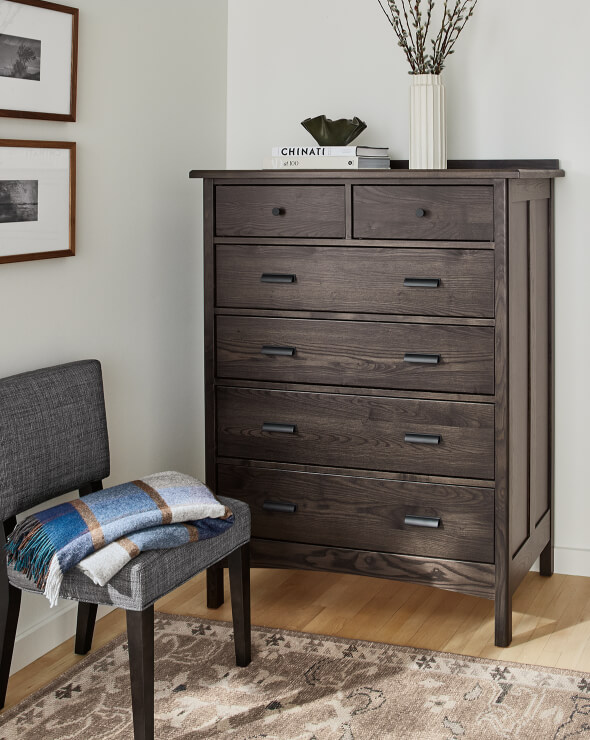 Atherton dresser in dark wood with five drawers, styled with books, a vase, and accent decor.