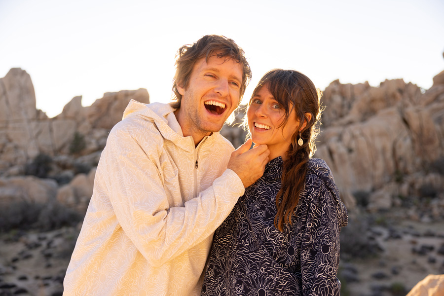 Man and a woman in the mountains laughing