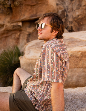 Photo of a man sitting on a rock