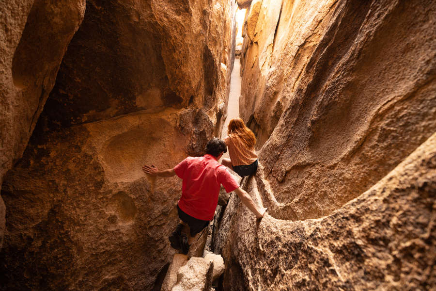 A couple climbing through a cav