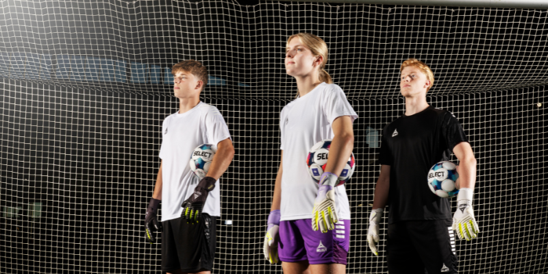 Goalkeeper wearing various gloves in front of a goal