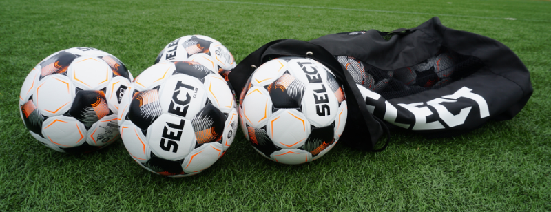SELECT Club balls with a duffle bag on a field
