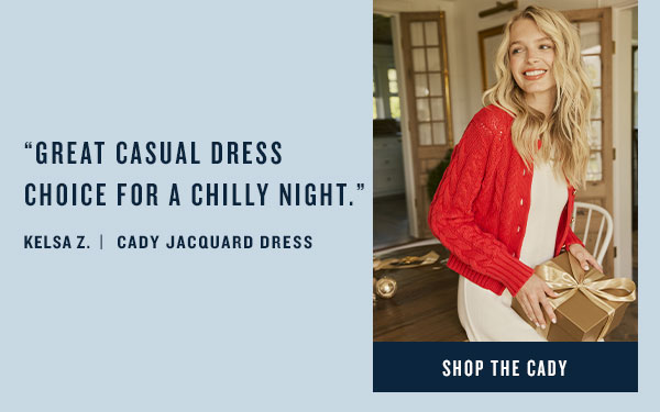 Woman in red sweater and white dress. Shop the Cady.