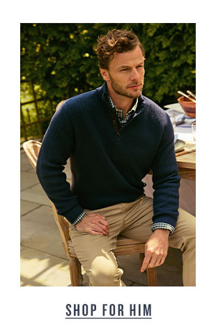 Shop For Him. Man in navy knit sweater and khaki pants.