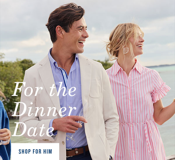 For the dinner date. Shop for him. Man in button down, blazer, and pants standing next to woman in striped midi dress.