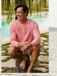 Man in salmon colored long sleeve and shorts.
