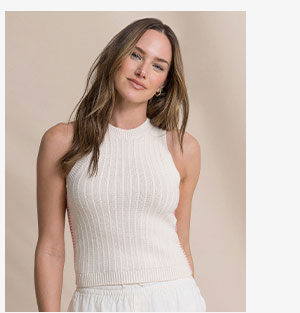 Woman in beige sweater tank.