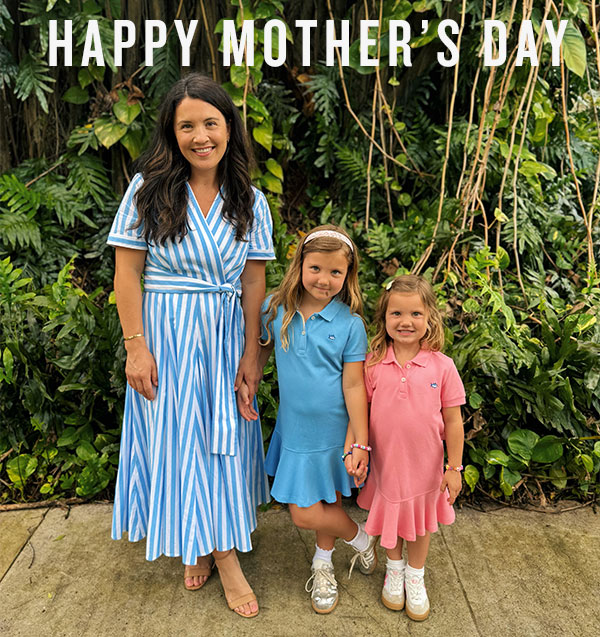 Happy Mother's Day. Woman in blue and white striped midi dress and her two daughters in blue and pink dresses.