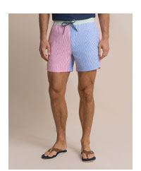 Man in color block seersucker swim trunks. 