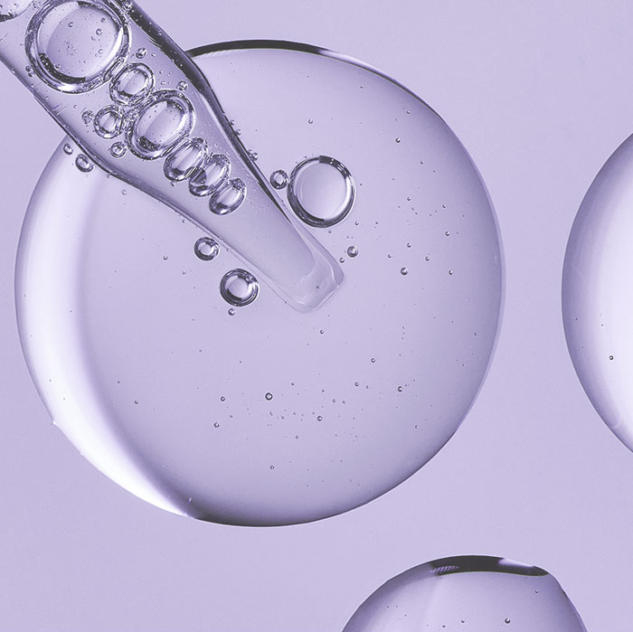 Hyaluronic Acid coming out of a pipette, showcasing the texture and fluidity of the ingredient.