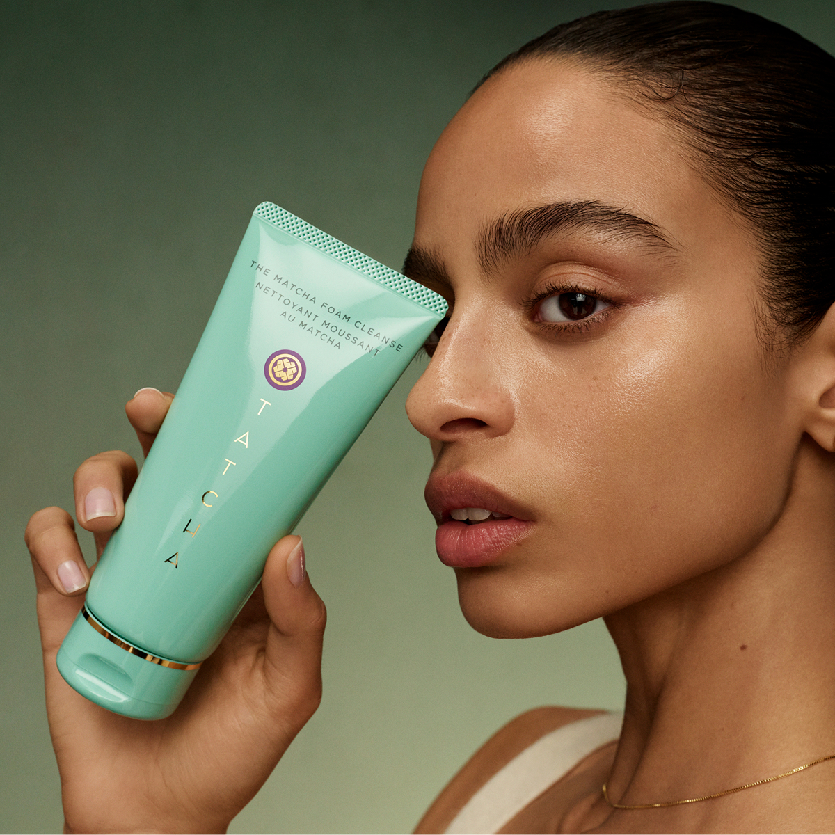 An image of a model holding the new Matcha Foam Cleanse by Tatcha.