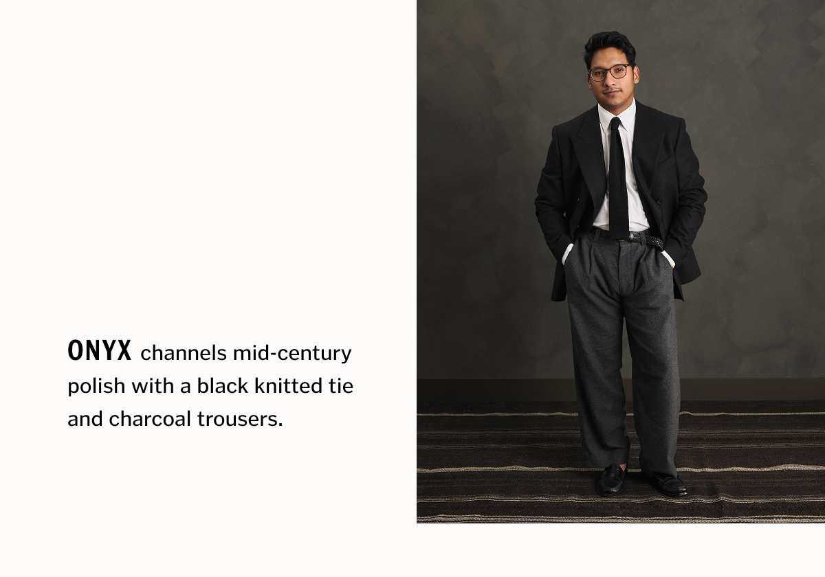 Onyx channels mid-century polish with a black knitted tie and charcoal trousers.