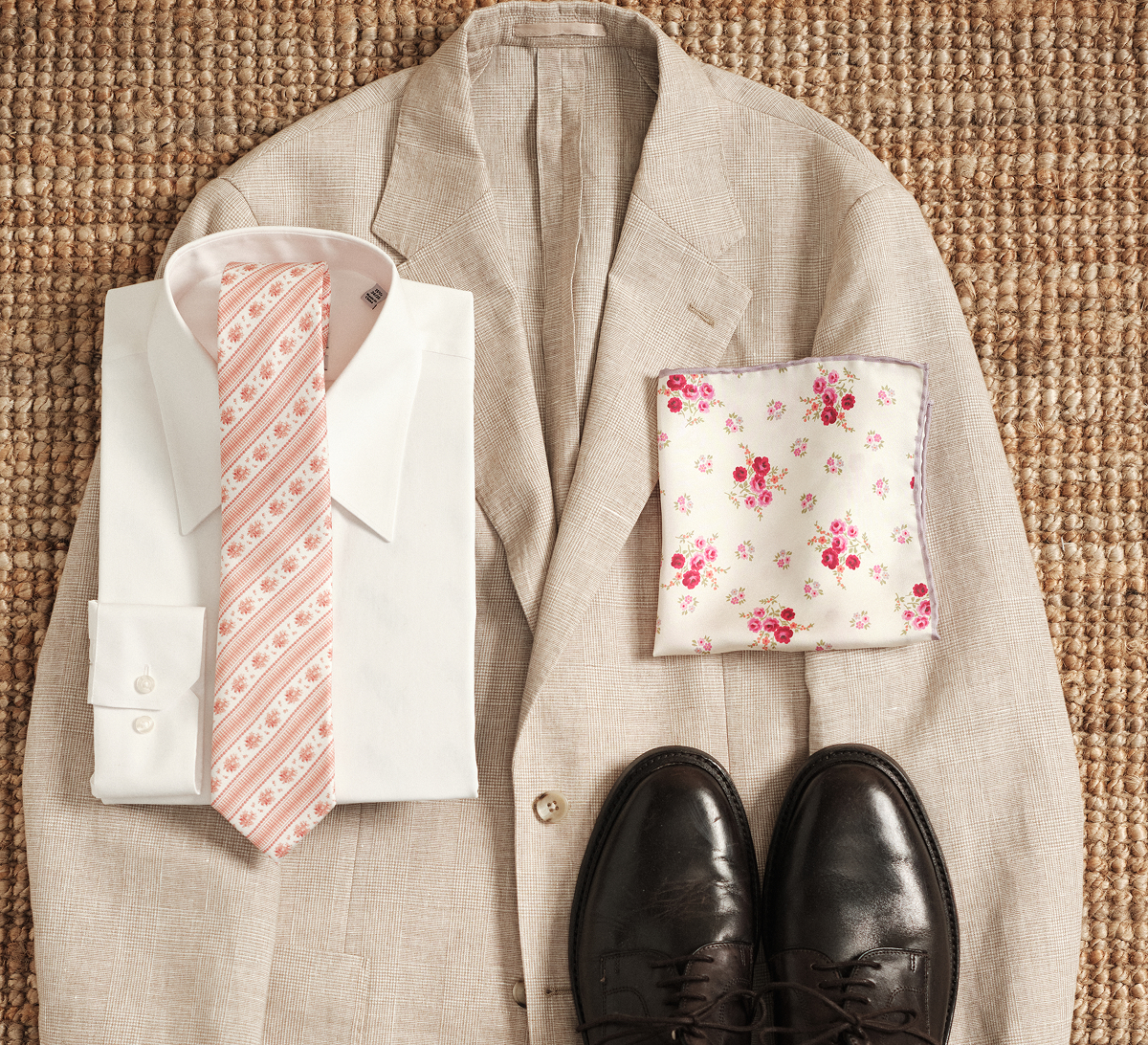 For the main event, keep it classic with a crisp white non-iron dress shirt and a floral tie from our Laura Ashley Collection for a look that feels celebratory without overdoing it.