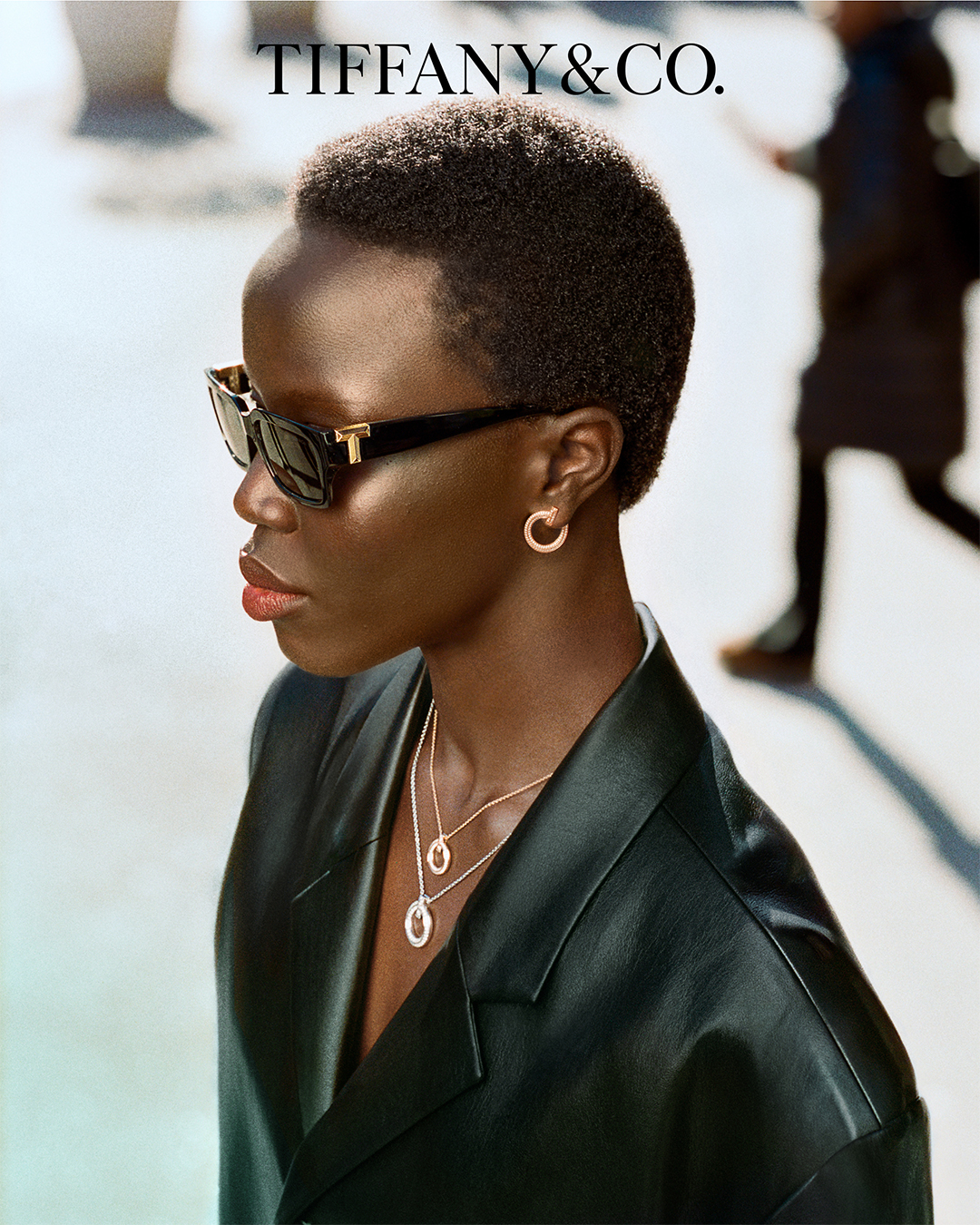 Woman wearing T Sunglasses, earrings & pendants