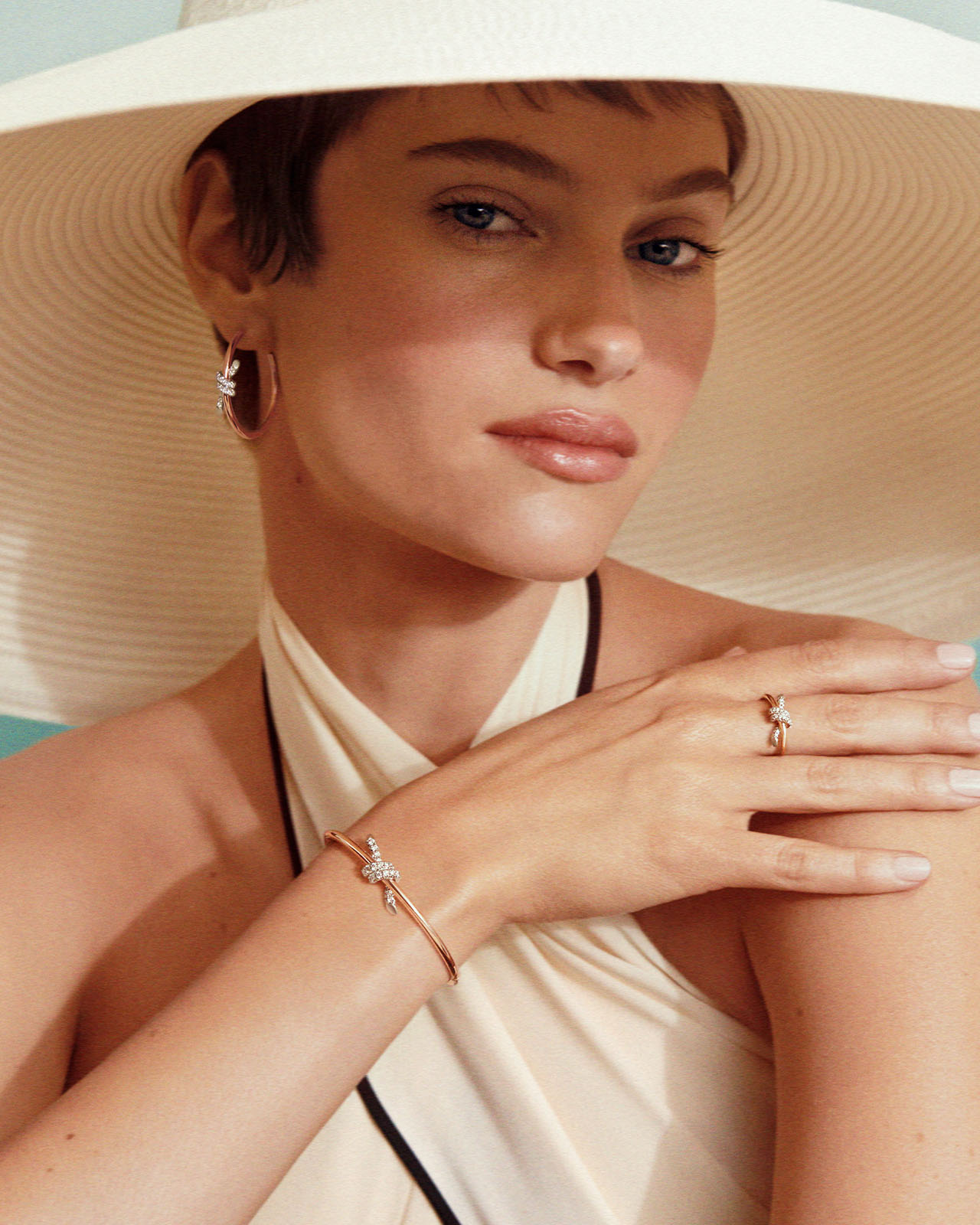Model wearing Knot by Tiffany jewelry with a mix of metal