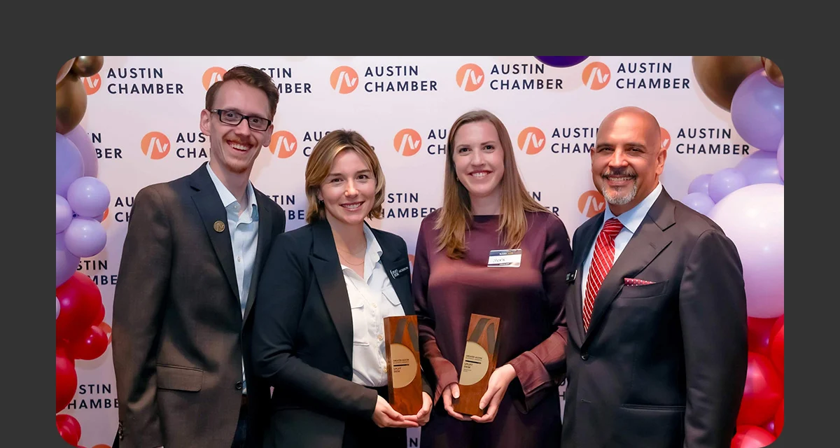 A group of UPLIFT Desk employees accepting the Environmental Champion Award